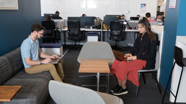 man and a woman working in lounge area of Future Labs