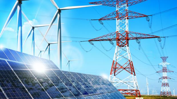 An electrical tower with wires being powered by wind turbines and solar panels.