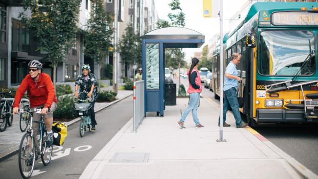 Stock photo of people biking and taking public transport