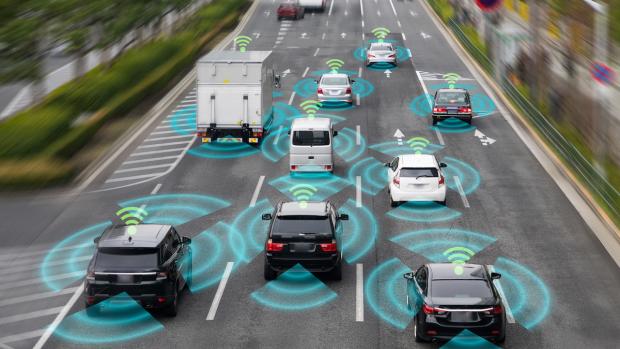 vehicles on a 4 lane road with wireless symbols above and space indicators surrounding them