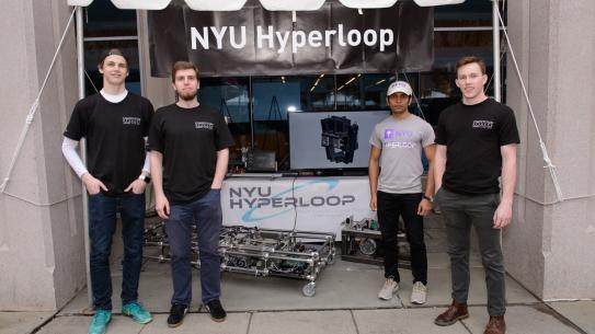 NYU Hyperloop team members with their prototype vehicle at the 2017 NYU Tandon Research Expo