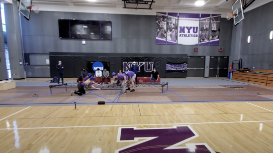 Tandon students work on steel bridge in NYU gymnasium