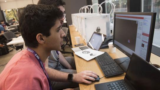 student in the makerspacce using desktop computer