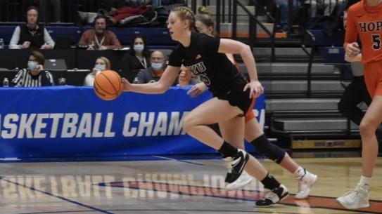 female student running with basket ball on the court