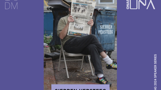 man sitting in a folding chair holding a newspaper in front of his face