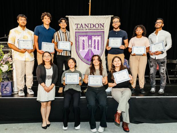 Tandon banner surrounded by group of diverse students holding certificates 