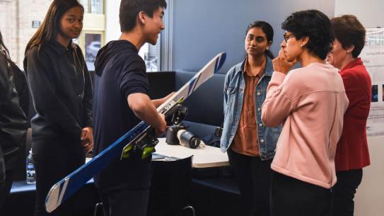 student holding a ski