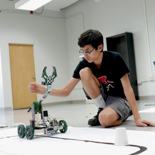 STEM student with robot