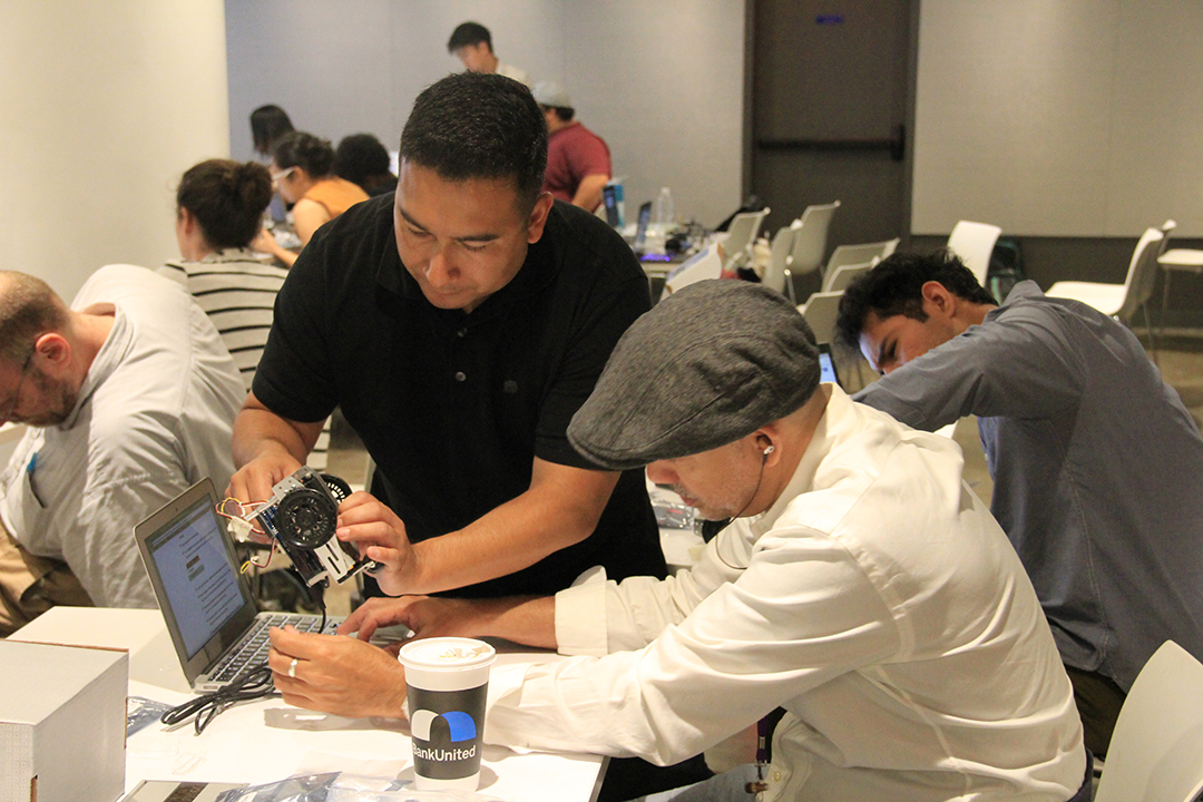 teachers constructing a wheeled robot 