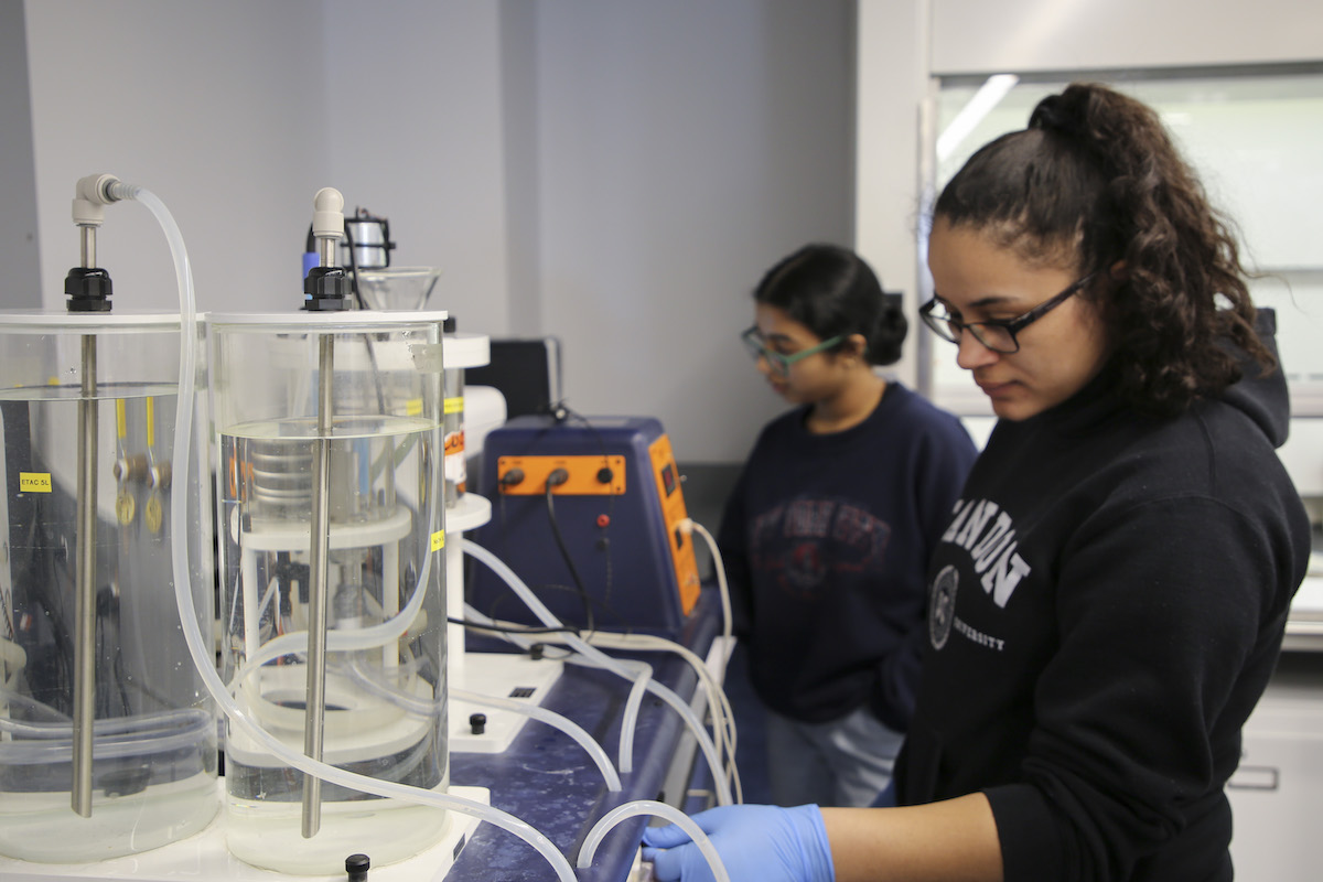 student working with lab equipment